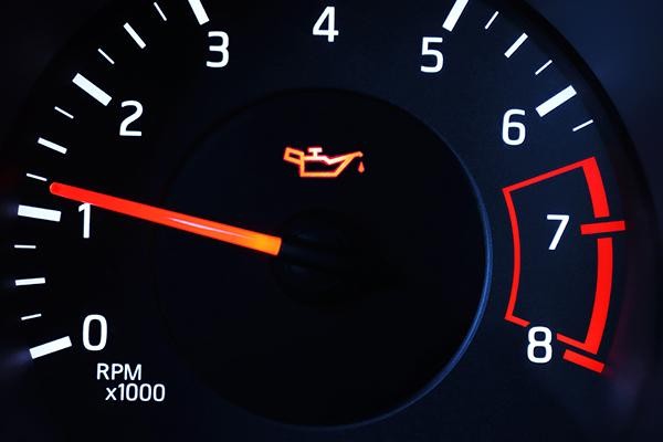 Vehicle dashboard showing the change engine oil warning